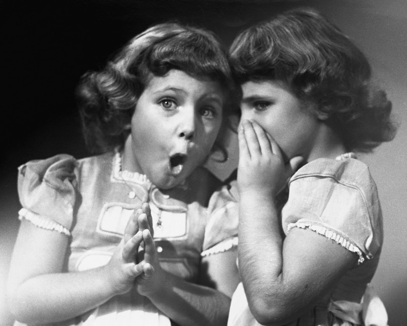 Twin sisters sharing secrets.  (Photo by George Marks/Retrofile/Getty Images)